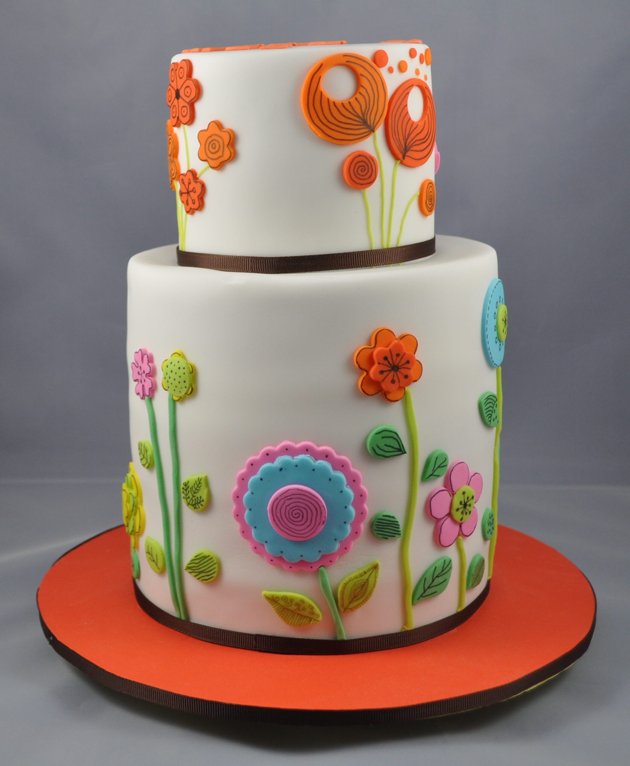 Two-tier cake with orange sugar flowers
